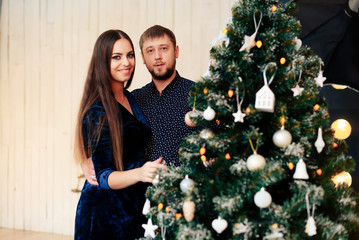 young beautiful couple in love in new year decor