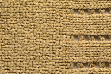 Beige Texture of a Knitted Sweater with Two Types of Knitting. Knit texture as background.