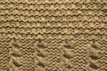 Fototapeta na wymiar Beige Texture of a Knitted Sweater with Two Types of Knitting. Knit texture as background.