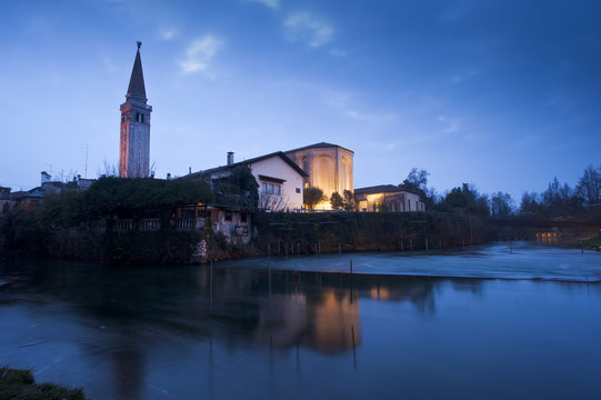 The San Nicol&ograve; Cathedral in Sacile is reflected on the Livenza river, Pordenone district. Italy