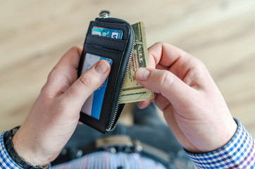 Man holding leather wallet