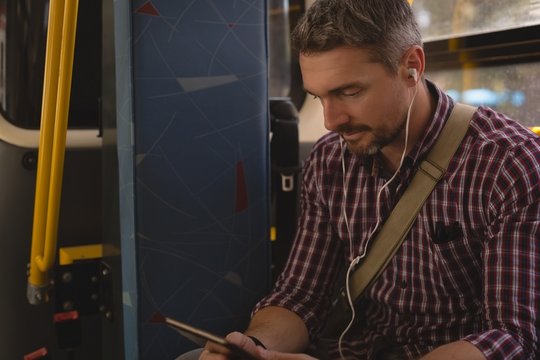 Man Listening Music On Digital Tablet