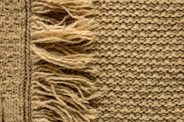 Knit Cloth with Fringe Background. Beige Knit Sweater Blank Backdrop