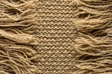 Knit Cloth with Fringe Background. Beige Knit Sweater Blank Backdrop