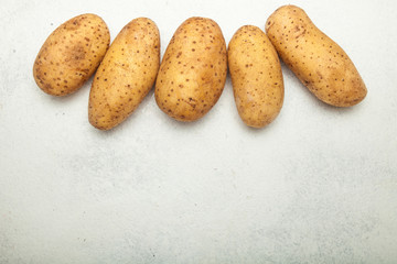 Organic potatoes on a white background, empty space for text.