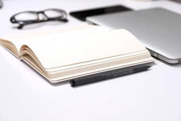 Notebook, pen and Laptop on White background