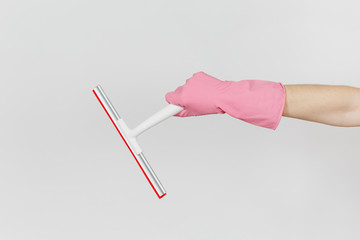 Close up of female hand in pink gloves horizontal holds white squeegee for surface cleaning with red elements isolated on white background. Cleaning supplies concept. Copy space for advertisement