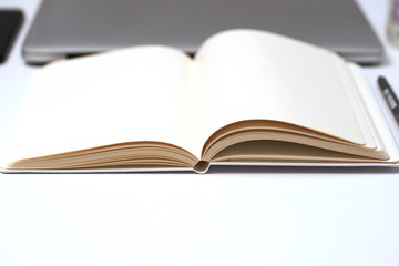 Notebook, pen and notepad on White background