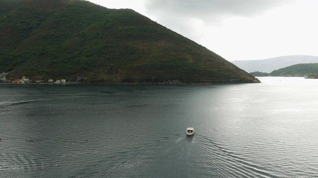 quick red white boat floating in the Bay with tourists
