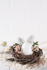 Fototapeta na wymiar Easter eggs decoration. Nest with white chicken egg. Happy Easter or spring greeting card