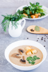Homemade mushroom cream soup with champignons and breadcrumb