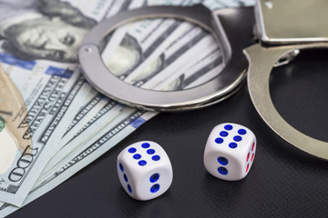 handcuffs and dollars. craps games. illegal casino arrest.