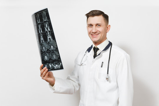 Happy handsome young doctor man holds x-ray radiographic image ct scan mri isolated on white background. Male doctor in medical uniform, stethoscope. Healthcare personnel, health, medicine concept.