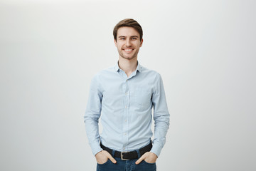 Confidence and business concept. Portrait of charming successful young entrepreneur in blue-collar...