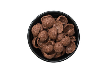 Top view of cocoa flavored cereal in black ceramic bowl isolated on white background with clipping path