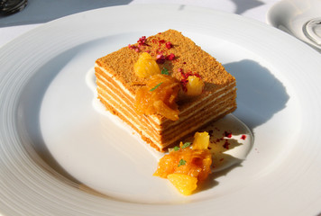 Macro photo of tasty honey cake with orange