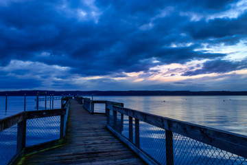 dark blue storm clouds over wooden dock
