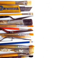 Fototapeta premium Artistic brushes in a row close - up on canvas. Professional artist's tool. The view from the top. Copy space.