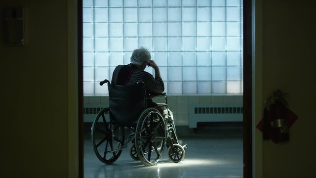 Elderly man in wheelchair forgotten in nursing home