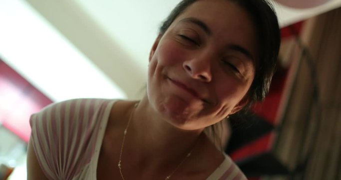 Goofy woman doing cross eyes expressions in front of camera. Girl doing grimaces and doing fish mouth face in 4K