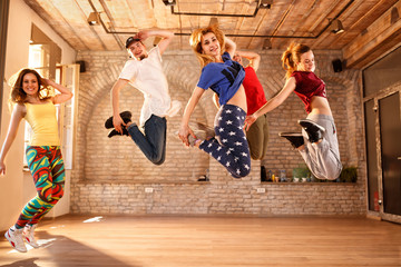 Group of young people jumping together