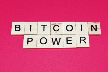 Wooden blocks on a red background spelling words Bitcoin Power