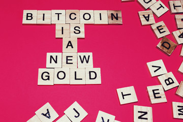 Wooden blocks on a red background spelling words Bitcoin is A new Gold