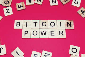 Wooden blocks on a red background spelling words Bitcoin Power