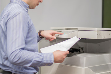 Copier Start, Finger pressing the start button on a multifunction printer or copier