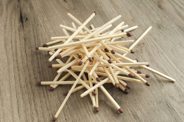 A pile of wooden safety long match sticks on wooden background