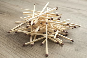 A pile of wooden safety long match sticks on wooden background