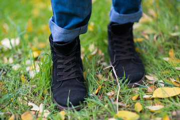 woman feet on green atumn grass