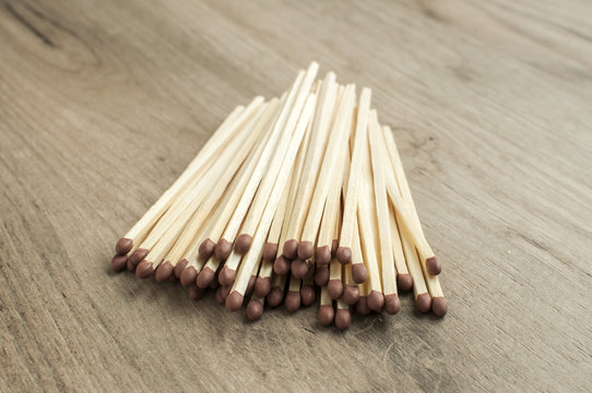 A pile of wooden safety long match sticks on wooden background