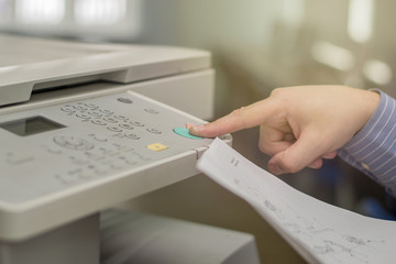 Copier Start, Finger pressing the start button on a multifunction printer or copier