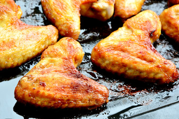 Roasted Chicken wings in oven black plate