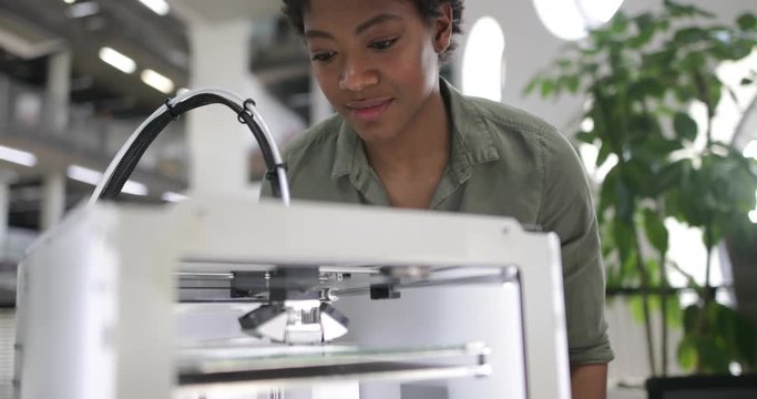 Female looking at 3D printer
