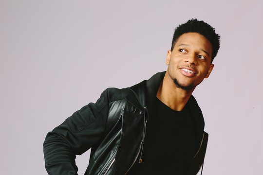 Portrait Of A Happy Young African American Guy Looking To The Side Isolated On Grey Studio Background