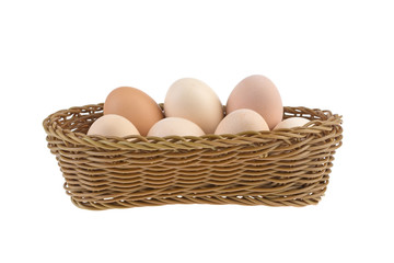 chicken eggs in a wicker basket isolated on a white background