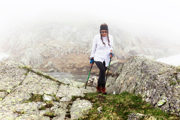 Girl hipster travels rocky mountains.