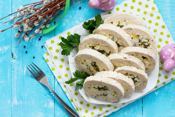 Easter recipe, festive appetizer. Meatloaf with egg, cheese and greens. Copy space, top view flat lay background.