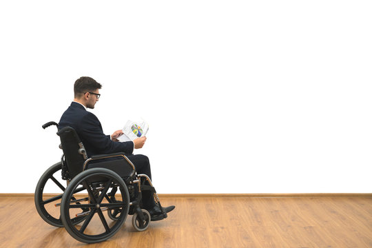 The disabled in a wheelchair holding papers on the white wall background