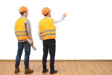 The two engineers gesture on the white wall background - obrazy, fototapety, plakaty