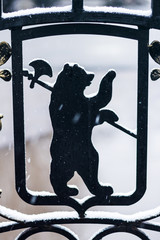 Bear with ax - Yaroslavl arms, Russia. Metal forged fence above the river