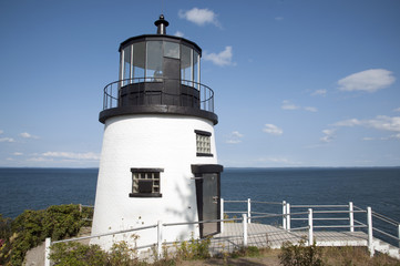 Fototapeta na wymiar Owls Head Lighthouse Overlooks Ocean Below in Maine