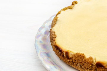 Cheesecake on white wooden table. Close up.