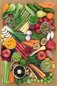 Super food for a healthy life with fresh fruit and vegetables high in antioxidants, anthocyanins, dietary fibre, protein,minerals and vitamins. On cork, top view.