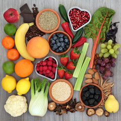 Diet health food concept with fresh fruit, vegetables, coffee, grains, nuts, chocolate, ginseng and tribulus terrestris herbal medicine used as an appetite suppressant and aphrodisiac. Top view.