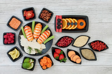 Diet health food dieting concept with high protein seafood and chicken, fruit, vegetables, nuts, legumes, grain and tribulus terrestris herb used as appetite suppressant.  Top view. on rustic wood.