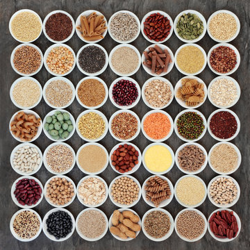 Macrobiotic health food selection of legumes, seeds, nuts, grains, cereals and whole wheat pasta with super foods high in protein, omega 3, anthocyanins, antioxidants, minerals and vitamins. 