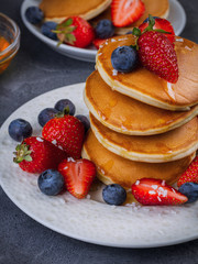 American pancakes with berries and honey